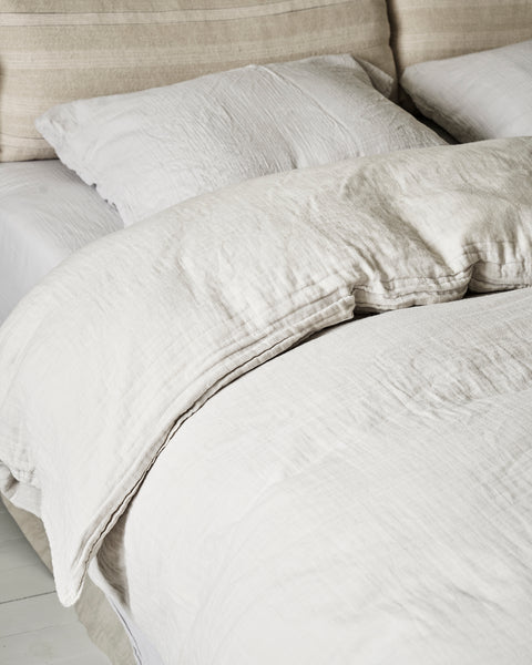 Bed made with light grey organic cotton gauze 