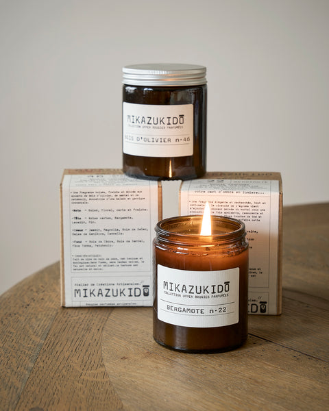 Mikazukidou candle with packaging on a wooden surface