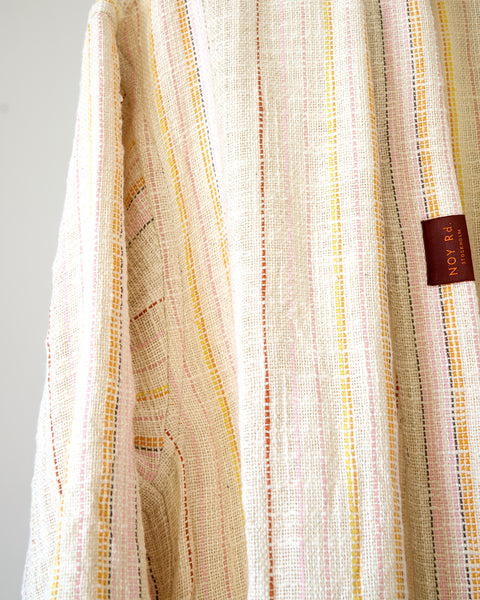 Textured fabric with a visible brand tag on a gray background